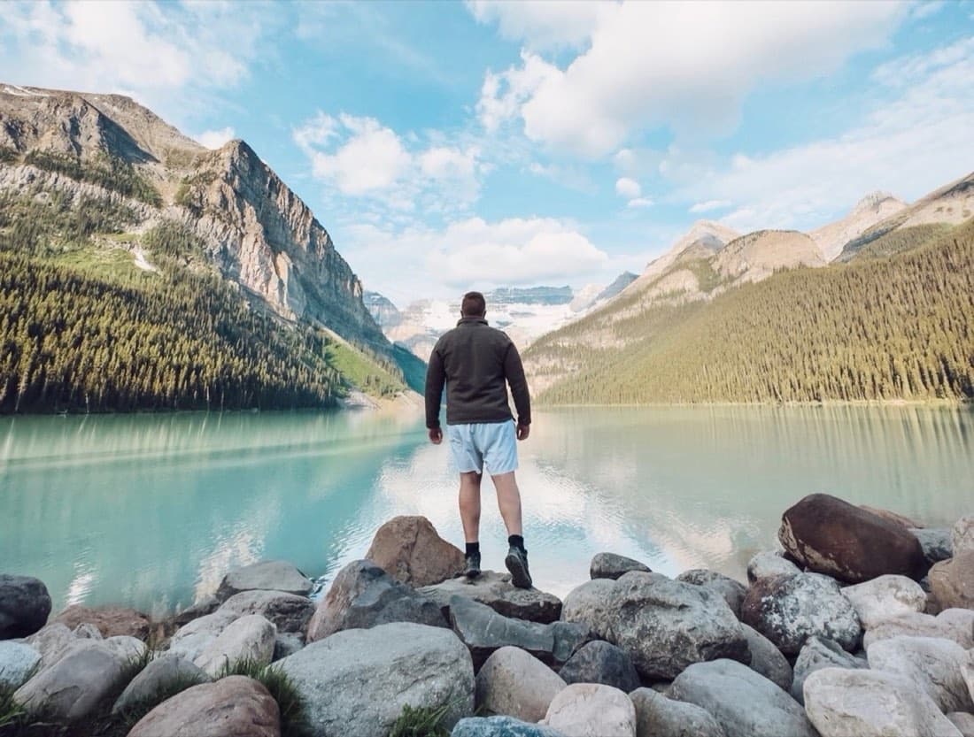 Alex at the edge of a mountain lake, off the clock
